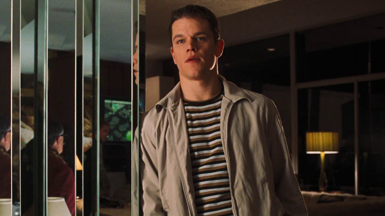 Matt Damon în rolul lui Linus Caldwell aplecat pe un zid în casa lui Danny din Ocean's Eleven