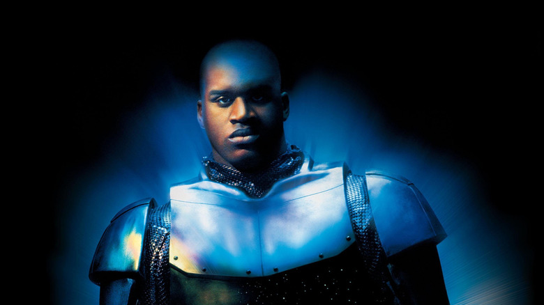 O imagine în stil poster pentru filmul oțel, cu John Henry Irons (Shaquille O'Neal) în centrul unei imagini cu un fundal întunecat