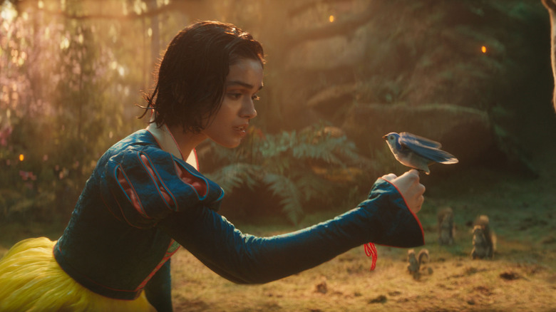 Albă ca zăpada lui Rachel Zegler care ține o pasăre albastră în Albă ca Zăpada (2025)