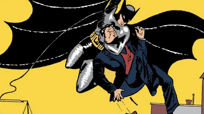 Detectiv Comics #27 copertă cu Batman care zboară pe funie care ține criminal în Headlock