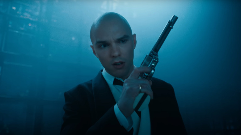 Lex Luthor care ține o armă într -o cameră întunecată în Supermanul lui James Gunn