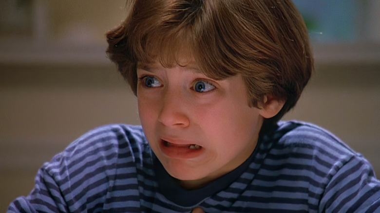 Un prim-plan al Nordului (Elijah Wood) care poartă o cămașă cu dungi cu o expresie în panică în nord