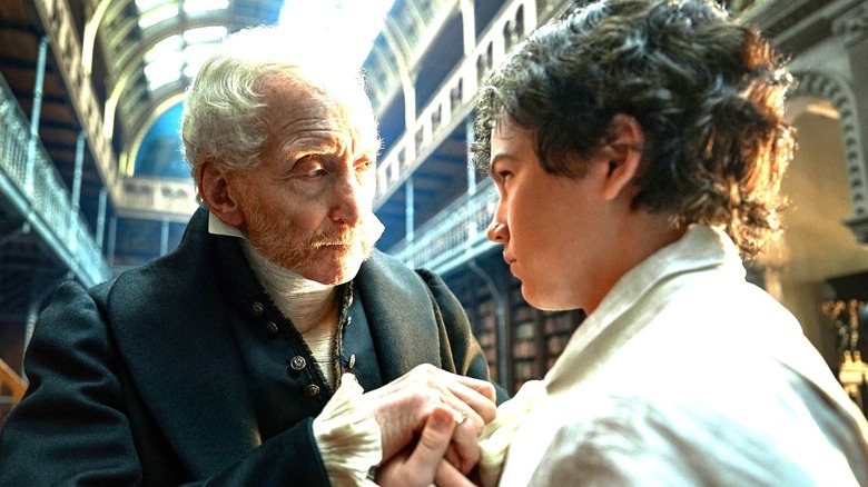 Frankenstein, Alphonse Frankenstein și tânărul Victor Frankenstein atingând mâinile într -o bibliotecă