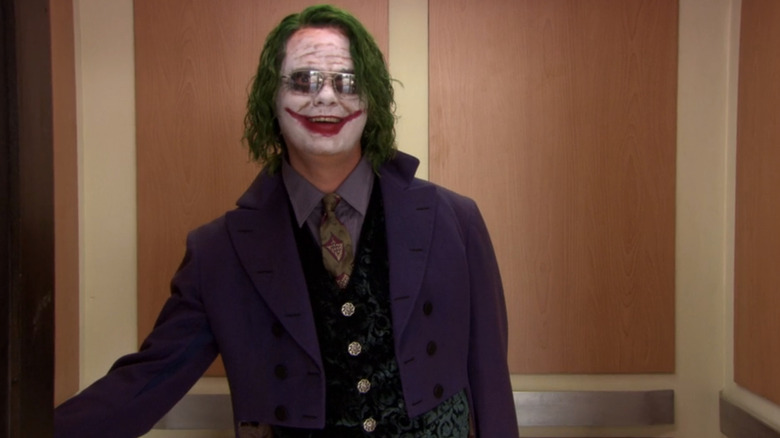 Rainn Wilson în timp ce Dwight Schrute stă într -un lift îmbrăcat ca Joker la birou