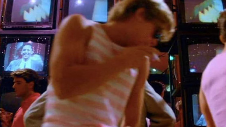 Brad Pitt ca figurant în fața mai multor ecrane TV în Less Than Zero