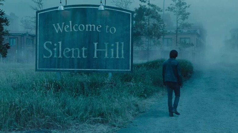 James trecând pe lângă indicatorul Bine ați venit la Silent Hill în Return to Silent Hill