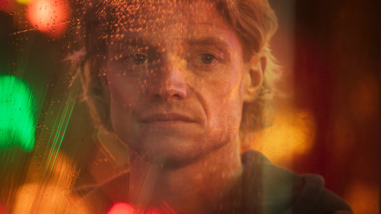 Tom Rhys Harries în rolul lui Matt Hagen privindu-se într-o fereastră în Clayface