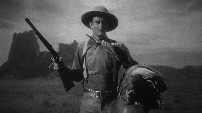 John Wayne mânuiește o pușcă ca The Ringo Kid în Stagecoach