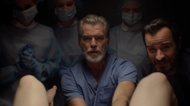 Dr. John Hindle din Pierce Brosnan este văzut făcând un copil alături de Adrian Martin al lui Justin Theroux în Fals Pozitiv