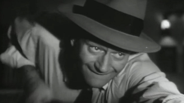 Steve Williams de la John Wayne se aplecă peste o masă de biliard în prim-plan în Trouble Along the Way
